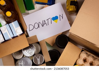 Donation For People From Ukraine. Food Donations Boxes With Grocery Products On White Desks. Top View