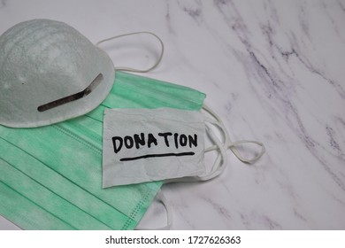 Donation write on sticky notes with health mask isolated on office desk - Shutterstock ID 1727626363