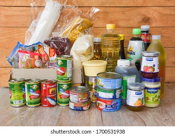 Donations Box With Canned Food On Wooden Table Background / Pasta Canned Goods And Dry Food Non Perishable With Oil Rice Noodles Spaghetti Macaroni Donations Food : Bangkok Thailand - 5 April 2020