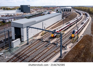 DONCASTER, UK - APRIL 15, 2022.  Aerial View Of Hitachi Azuma Class 800 Bi Modal Passenger Trains Under Overhead Electric Wires On Doncaster Maintenance Depot