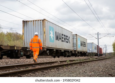 DONCASTER, UK - APRIL, 4, 2021.  A Railway Worker Inspecting A Maersk Shipping Container Freight Train On The UK Rail Network Before Export Or Import.