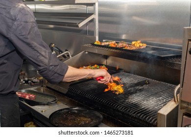 Doncaster, UK - May 11 2019: One Chef Cooking Flame Grilled Steak On A Hot Grill On A Busy Saturday Night Dinner Service On 11 May At La Boca Argentine Restaurant, 1 Netherhall Road