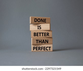 Done is better than Perfect symbol. Wooden blocks with words Done is better than Perfect. Beautiful grey background. Business and Done is better than Perfect concept. Copy space.
