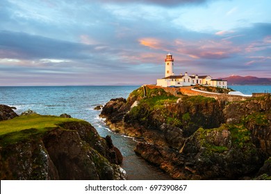 Donegal, Ireland. Fanad head at Donegal, Ireland with lighthouse at sunset. Colorful sky, mountains and sea
