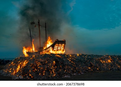 Donggang,Pingtung County,Taiwan,October 31, 2021:People set a huge wooden boat on fire, and believe that doing so can eliminate the bad luck in this area