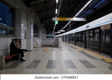 Dongjak, Seoul / South Korea - April 29 2018: Man Sitting On A Bench On The Platform Of Dongjak (Seoul National Cemetery) Station On The Seoul Subway Line 4.