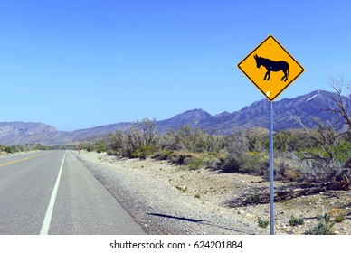 Donkey Or Burro Crossing Warning Sign On Road In The Desert In The Southwest, USA