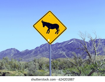 Donkey Or Burro Crossing Warning Sign On Road In The Desert In The Southwest, USA