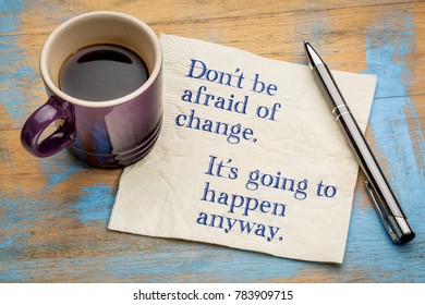 Don't be afraid of change. It's going to happen anyway. Handwriting on a napkin with a cup of espresso coffee