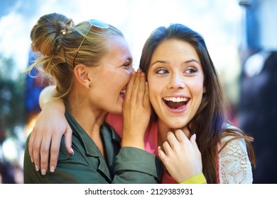 I Dont Believe It. A Young Woman Whispering A Secret In Her Friends Ear.