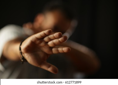 Don't doit! hand of man in stop sign to violence against man, against woman, against abuse, against abuse, in black background and dramatic light - Shutterstock ID 612771899