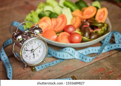 Don't Eat After Six For A Pretty Body. Vegetables And Clock. Diet Concept