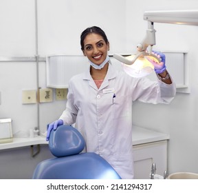 Dont forget to schedule regular checkups with your dentist. Portrait of a young female dentist standing alongside the dental chair in her office. - Shutterstock ID 2141294317