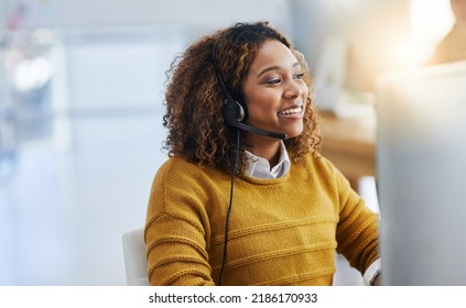 Dont forget to smile. Shot of a female agent working in a call centre. - Powered by Shutterstock