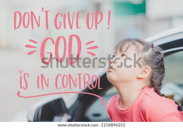 Don\'t Give up GOD is in\
control.encouragement word from bible and Looking up little asian\
girl in the car.Little child girl waiting and seeking\
GOD.