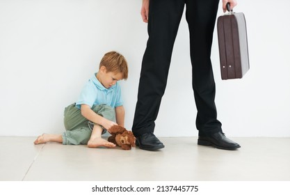 Dont Go.... A Young Boy Holding A Teddybear And Looking Sad Because His Dad Has To Go To Work.