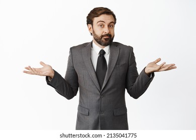 I dont know. Clueless businessman shrugging shoulders, looking confused, puzzled to answer, have no idea, standing in work suit against white background - Powered by Shutterstock