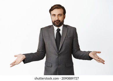 I Dont Know. Clueless Realtor, Salesman In Suit Shrugging And Looking Confused, Being Unaware, Standing Over White Background