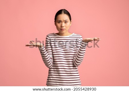 I Don't Know. Puzzled Asian Female Shrugging Shoulders And Looking At Camera, Hesitant Unsure Korean Female Having Difficult Choice, Standing Isolated Over Pink Studio Background, Copy Space