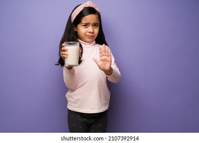 I Don't Like Milk. Upset Elementary Child With A Lactose Intolerance Refusing To Drink A Glass Of Milk 