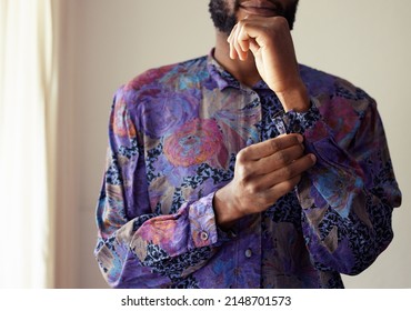Dont I look dapper. Shot of an unrecognizable man buttoning a shirt at home.