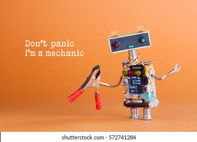 Don't panic I'm a mechanic concept. Toy robot handyman with pliers ready for service work. Fun character colorful head red blue light bulbs eyes. Repairing concept, orange background 