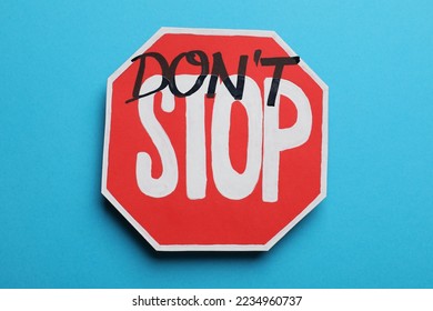 Don't stop - motivational phrase. Road sign sticker with added written text on light blue background