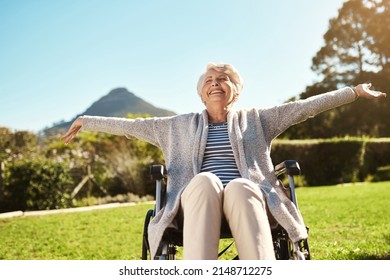 Dont take away their freedom. Shot of a senior woman enjoying the outdoors while sitting in her wheelchair. - Powered by Shutterstock