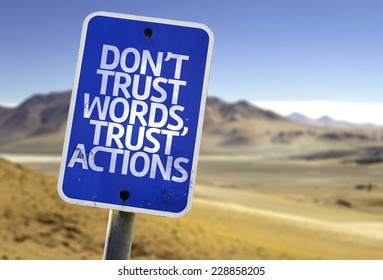 Don't Trust Words, Trust Actions sign with a desert background