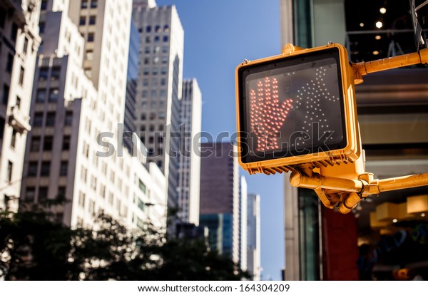 Don\'t walk New York traffic sign with\
illuminated and blurred\
background