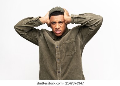Don't want to listen. Portrait of despaired man irritated by loud noise covering ears and grimacing in pain, suffering annoying high-decibel sound. Indoor studio shot isolated on white background