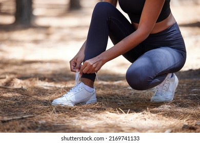 I Dont Want To Trip During This Run. Cropped Shot Of An Unrecognizable Woman Crouching Down And Tying Her Shoelaces Before Her Run Outdoors.