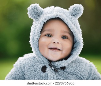 Dont you just wanna cuddle this cutie. Portrait of an adorable baby boy wearing a furry jacket with bear ears outdoors. - Powered by Shutterstock