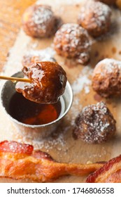 Donut Or Doughnut Holes, Deep Fried And Coated With Cinnamon, Powdered Sugar And Served With Vermont Maple Syrup And Crispy Bacon. Classic American Restaurant Breakfast Or Brunch Favorite.