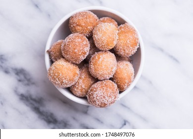 Donut Holes With Sugar On Bowl Over Marble