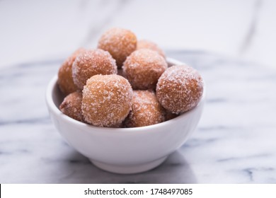 Donut Holes With Sugar On Bowl Over Marble