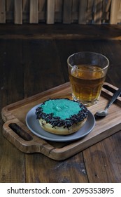 Donut With Mint Chocolate Topping And A Cup Of Tea, On Wooden Tray.  Selective Focus