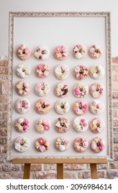 Donut Wall With Lots Of White And Pink Donuts