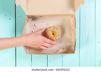 Donuts In Box On Wooden Table. Top View