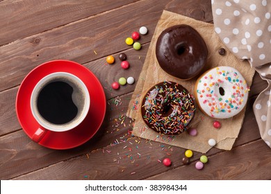 Donuts and coffee on wooden table. Top view - Powered by Shutterstock