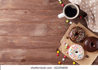 Donuts and coffee on wooden table. Top view with copy space - Powered by Shutterstock