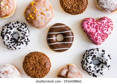 Donuts with colorful icing on a white background. The concept of junk food. Background for design.