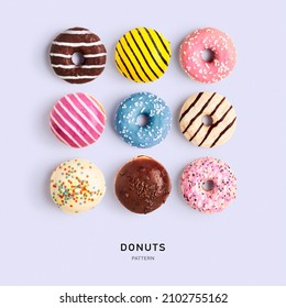 Donuts Creative Pattern On Color Background. Healthy Sweet Food And Holiday Concept. Tasty Dessert With Colorful Berliner Doughnuts. Flat Lay, Top View. Design Element. Color Card
