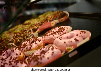 Donuts In A Display Case Inside A Bakery