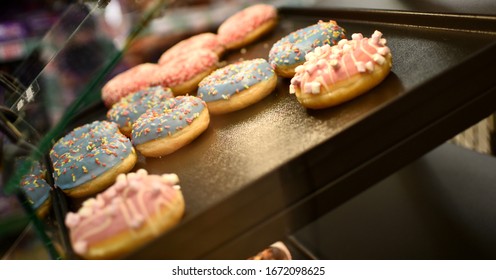 Donuts In A Display Case Inside A Bakery