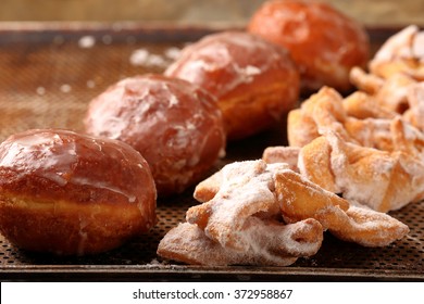 Donuts and faworki. Traditional Polish cookies on Fat Thursday 