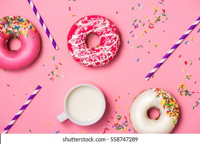 Donuts With Icing And Milk On Pastel Pink Background. Sweet Donuts.