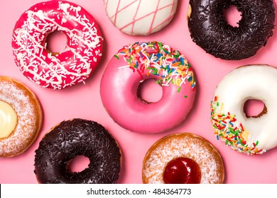 Donuts With Icing On Pastel Pink Background. Sweet Donuts.