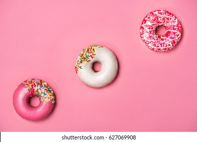 Donuts With Icing On Pastel Pink Background. Sweet Donuts.