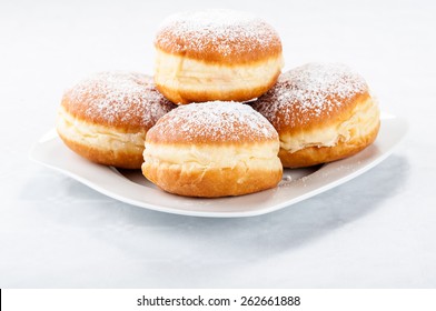 donuts-on-white-plate-260nw-262661888.jpg